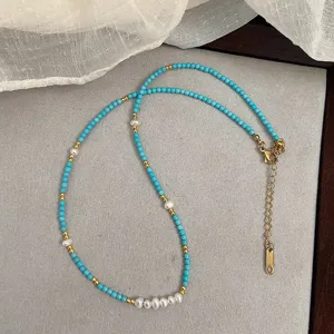 Detailed view of natural freshwater pearls and blue stone beads on a dainty necklace
