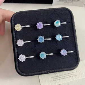 Detailed view of multi-colored firework cut gemstone ear cuffs in a black velvet box