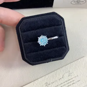 Macro view of fireworks cut light blue crystal ear cuff in black velvet jewelry box