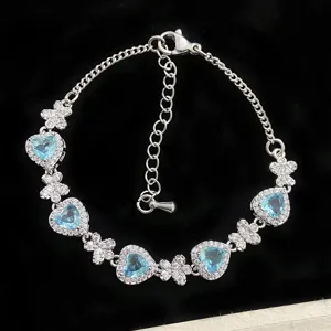 Bracelet en argent élégant avec pierres bleues en cœur et papillons en cristal