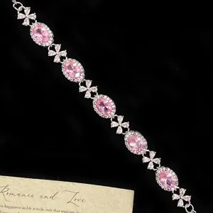Elegant French style bracelet with pink oval gemstones and silver floral zircon links.