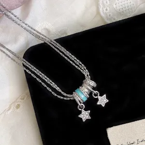 Collana a strati in argento con pendenti a stella, cristalli e perla turchese