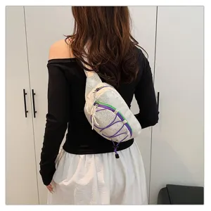 Rear view of a white sporty crossbody bag with purple and green accents on a model