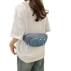 Blue sporty waist bag with elastic cord detail shown on a woman wearing white T-shirt.