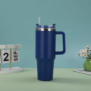 Close-up of a 40oz navy blue stainless steel insulated tumbler with handle and straw.