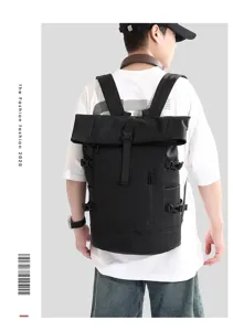 Rear view of a stylish black roll-top business laptop backpack worn by a male model