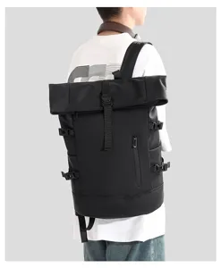 Detailed back view of a large black roll-top laptop backpack worn by a model