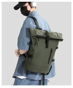 Side view of a large green roll-top business backpack on a model with techwear accessories.