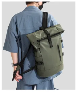 Detailed back view of a male model wearing an army green waterproof roll-top backpack