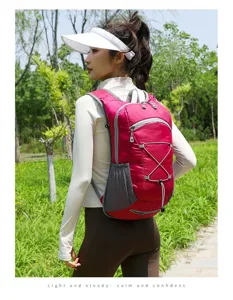 Lightweight pink hiking backpack with elastic cord system for outdoor sports.