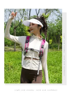 Asian female model wearing a lightweight magenta hiking backpack in an outdoor park setting