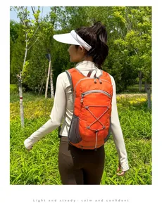 Lightweight orange cycling backpack for outdoor sports and hiking activities shown on model
