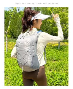 Grey lightweight cycling backpack for hiking and outdoor sports on female model
