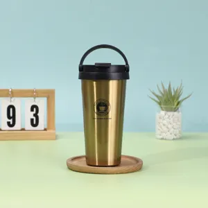 Stainless steel insulated coffee tumbler with handle and wooden coaster detail scene.