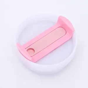 Detailed top view of a clear and pink spill-proof replacement lid for 20oz tumblers