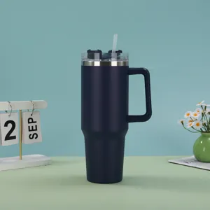 Navy blue 40oz stainless steel vacuum insulated tumbler with handle and straw on desk