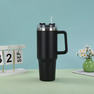 Macro view of 40oz matte black insulated tumbler with straw and handle