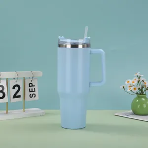 Light blue 40oz stainless steel insulated tumbler with handle and straw on desk setup