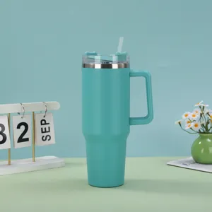 Teal 40oz insulated stainless steel tumbler with handle and straw on a tabletop.