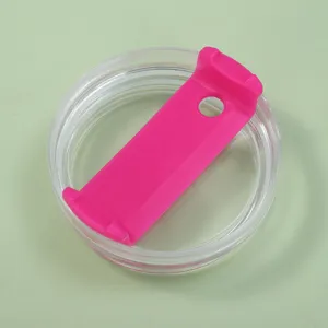 Close-up detail of a pink replacement lid for a 40oz tumbler on green background