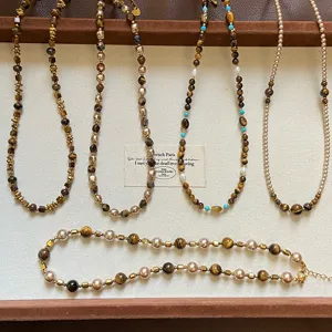 Detailed view of Maillard style natural tiger's eye and pearl beaded necklaces collection.