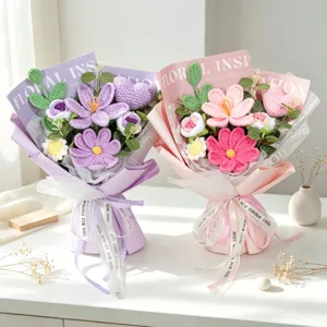 Detail view of handmade crochet yarn flower bouquets in purple and pink gift packaging