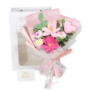 Close-up of handmade crochet flower bouquet with heart and roses in pink wrap