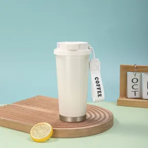Vue détaillée du mug de voyage isotherme en acier inoxydable blanc avec sangle de transport.