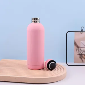 Matte pink 304 vacuum stainless steel sports water bottle with open lid on wooden tray