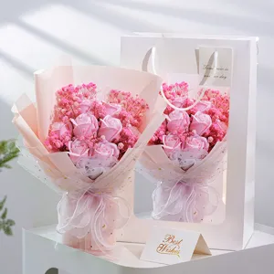 Close-up view of the exquisite pink soap rose and baby's breath bouquet with gift bag and card.