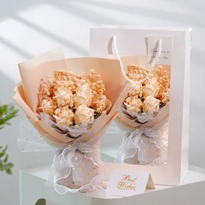 Close-up detail of champagne soap rose bouquet with baby's breath, elegant gift bag.