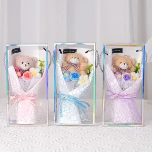 Three colorful knitted flower bouquets with plush bears in iridescent gift boxes.