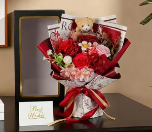 Detailed presentation of a luxury red rose soap flower bouquet with a teddy bear
