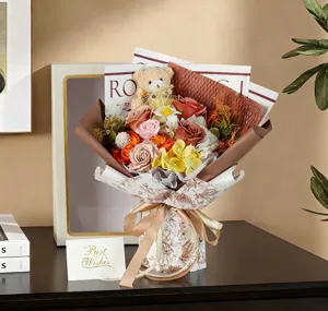 Detailed view of handmade soap rose bouquet with cute teddy bear and ribbon bow