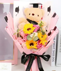 Graduation plush bear bouquet with artificial soap flowers, pink wrapping paper, gift box.