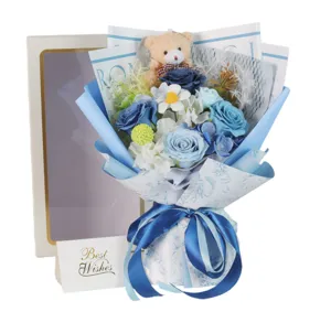 Detailed view of a blue soap rose bouquet with a teddy bear, gift box and Best Wishes card