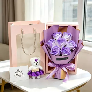 Detailed view of a purple soap rose bouquet set including a teddy bear and gift bag