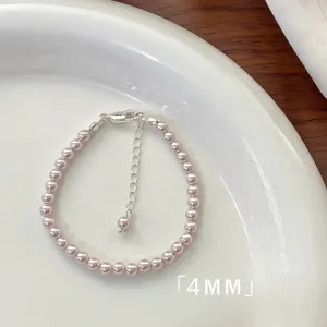Elegant 4mm pink pearl bracelet with adjustable silver extension chain on a white plate