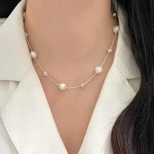 Elegant pearl starry chain necklace shown in a close-up on a fashion model's neck.