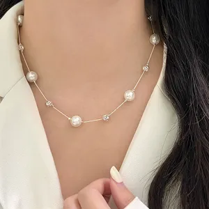 Close-up of elegant pearl and silver bead starry necklace on female model