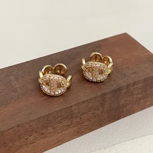 Detailed macro shot of gold-plated pig nose ear cuffs with pavé zirconia stones