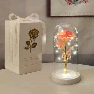 Dettaglio della rosa artificiale illuminata in una cupola di vetro con luci a LED.