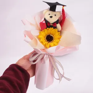 Detailed view of graduation sunflower bouquet with cute bear doll, perfect gift for students.