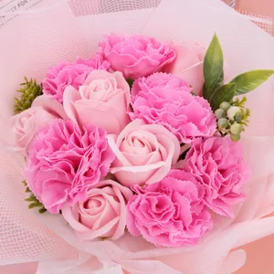 Detailed shot of pink soap rose and carnation bouquet, perfect romantic gift for graduation.