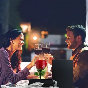 Preserved rose in glass dome presented in a romantic dinner scene for gift-giving