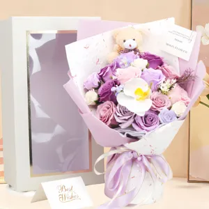 Detailed view of an 18 purple soap roses bouquet with a bear and a gift box
