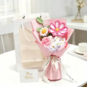 Detailed view of a handmade crochet bouquet featuring pink cosmos and white flowers