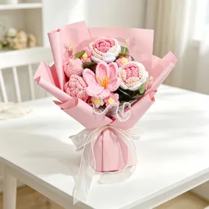 Detail view of handmade pink crochet flower bouquet with roses and organza ribbon