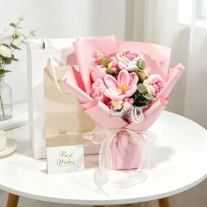 Close-up of handmade crochet rose bouquet with gift bag and greeting card.