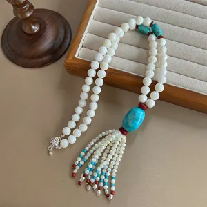 Ethnic style long beaded necklace featuring turquoise stone and shell bead tassel